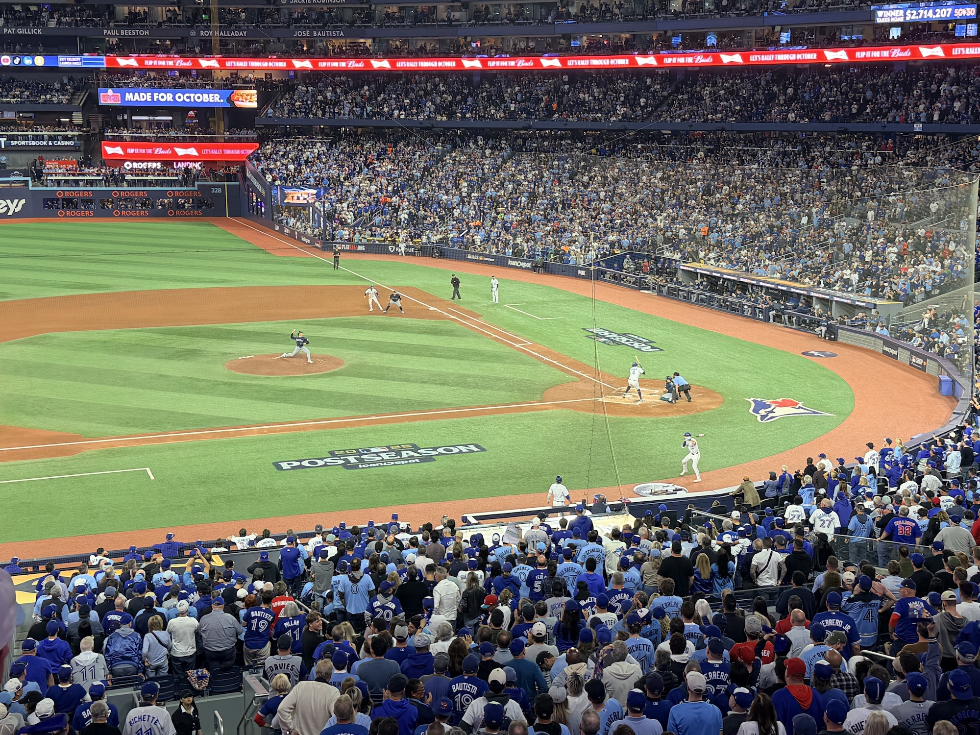A packed baseball stadium during a postseason game showing the field from an elevated angle with players positioned on the diamond and thousands of fans filling the stands.